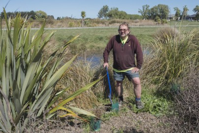 Dr Colin Meurk planting a riparian margin